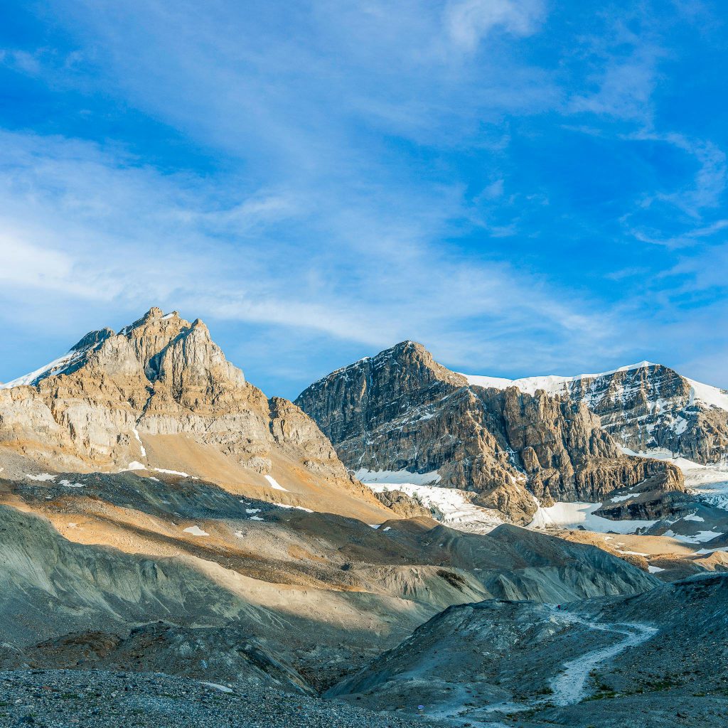 Breathtaking view of the rugged rocky mountains in Banff, Alberta under a clear blue sky.