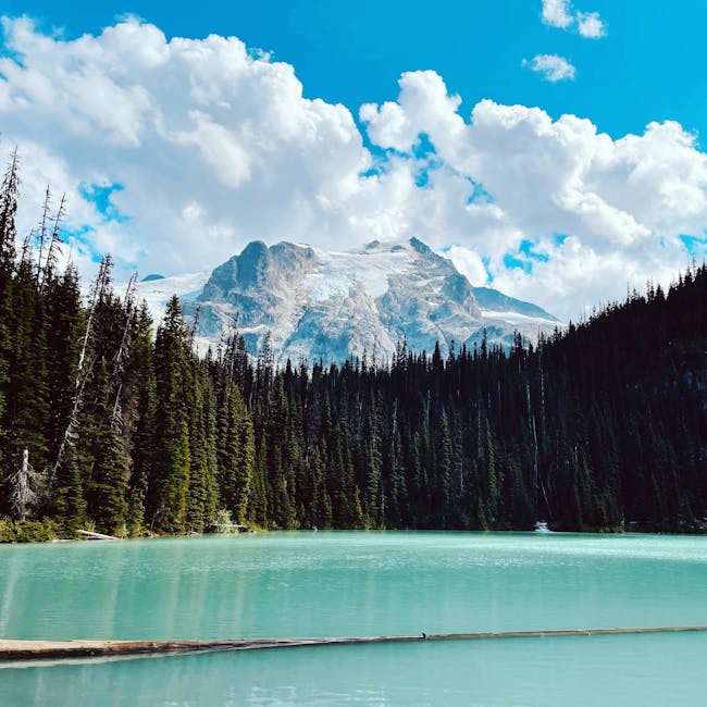 Stunning turquoise lake and snow-capped Mount Currie under a bright blue sky in British Columbia.